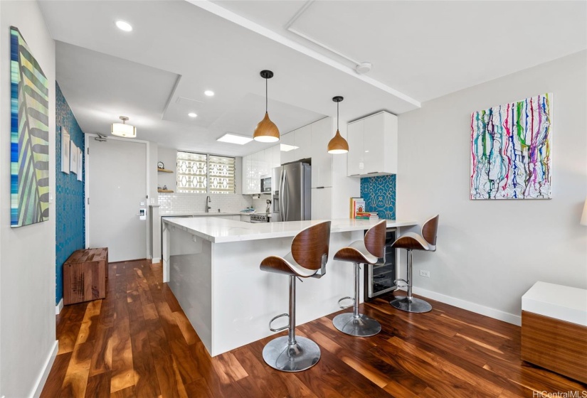 Open kitchen with counter seating for dining.