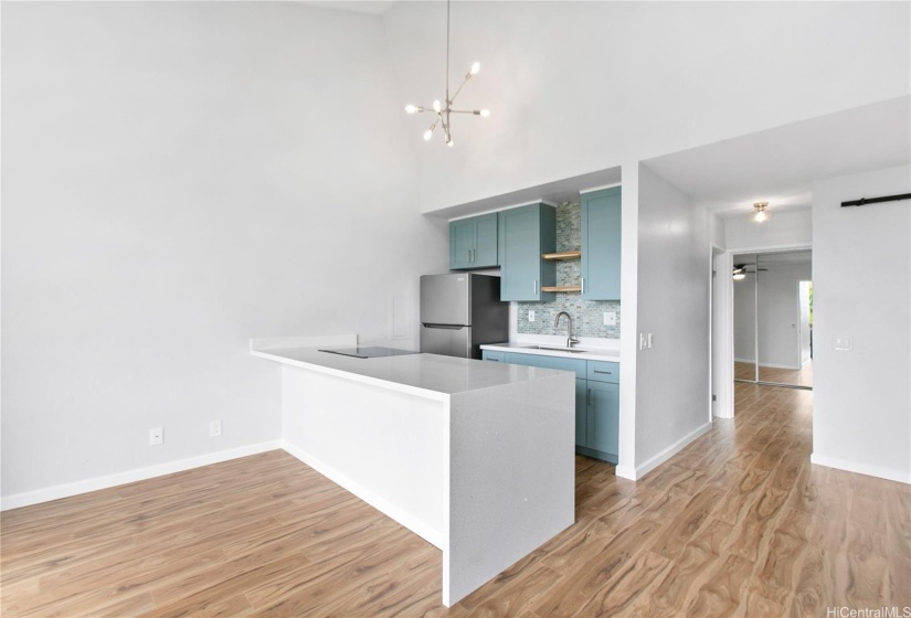 Waterfall quartz countertop.  Large counter overhang.  Perfect place for bar stools and mingling while you cook.