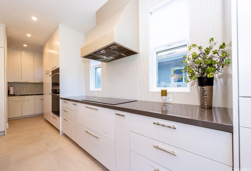 View of kitchen towards butlers pantry. Owner designed this kitchen to be able to have clear counters. Theres a pull out cabinet where the coffee station is.