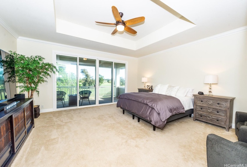 Primary bedroom with balcony overlooking the Hawaii Prince golf course.