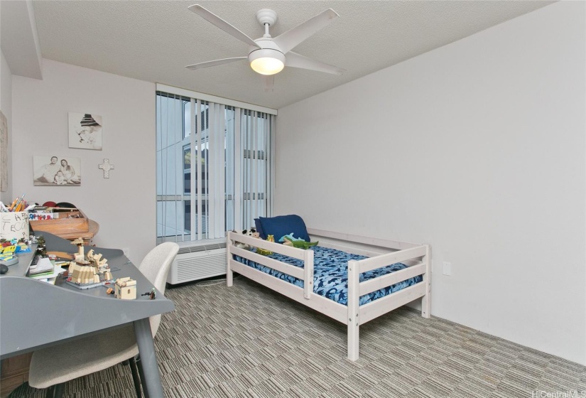 Second bedroom has window with view, ceiling fan and covered blinds for privacy.   Furniture not included.   Split a/c unit also located in this room.