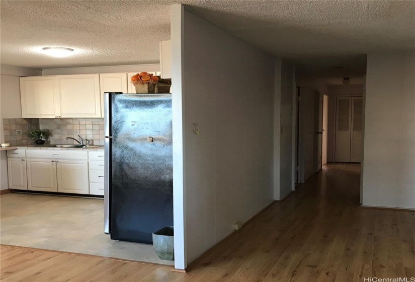 Hallway and partial kitchen view