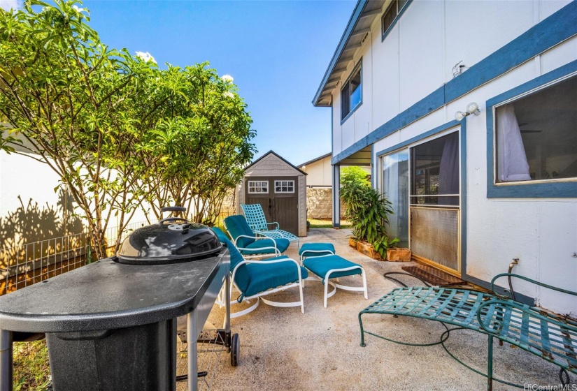 The lanai is cemented and great for barbecue and entertainment. There is a grassy area as well behind the shed.