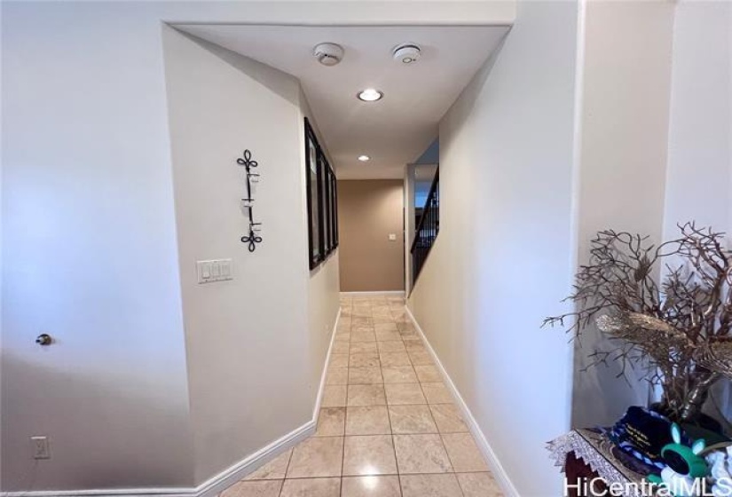 Hallway from entry door leading to Kitchen (Left) and Living Room (Right).  Den/#6 on the right side of the entry door.