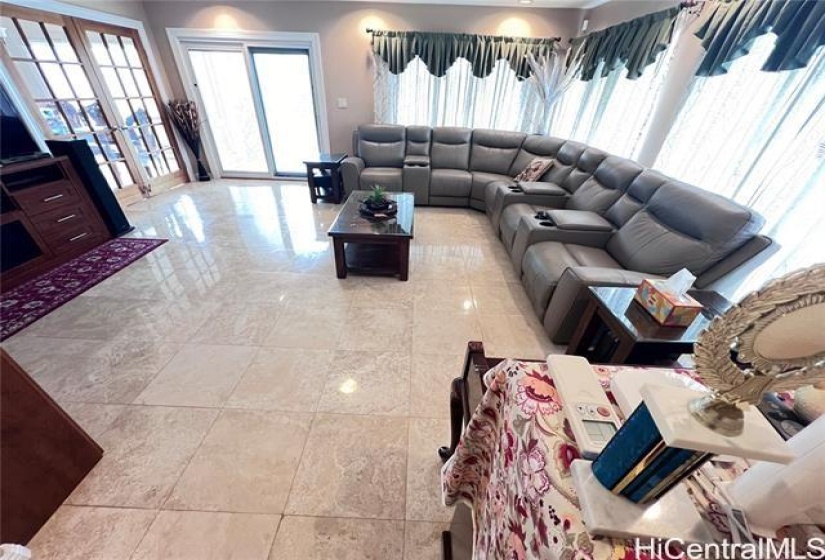 Living Room from entry door with access to outside.  Pellas sliding door with built in blinds. Double Door separating the Dining area for privacy.