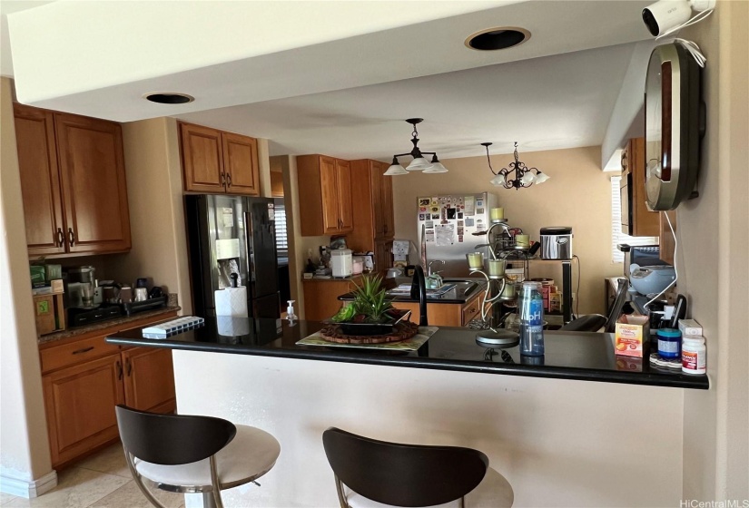 Kitchen area with lots cabinetry.  Built in speaker (entertainment system).