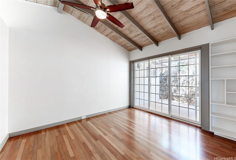 Left side bedroom with sliding doors leading to the back patio area.