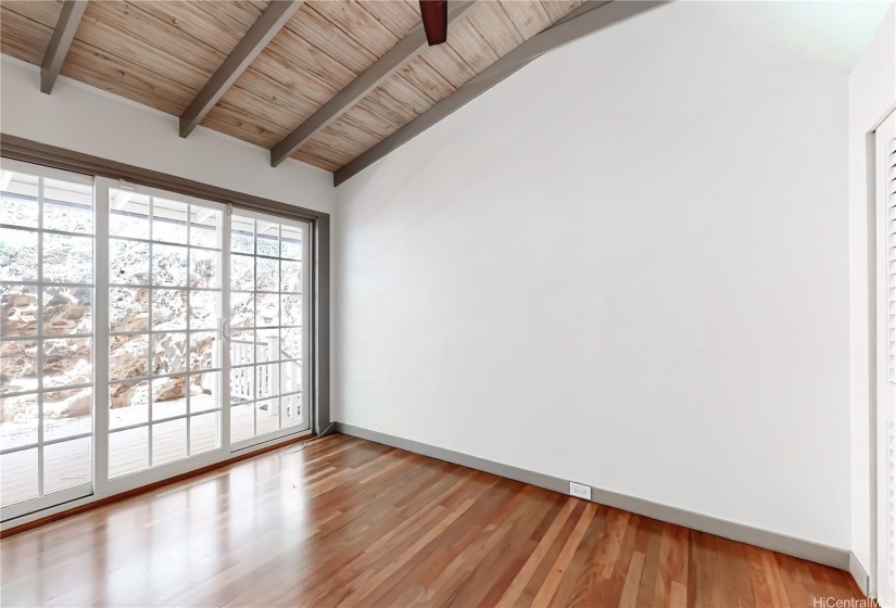 Right side bedroom with sliding doors leading to the back patio area.