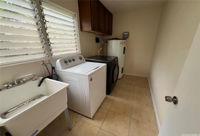 Laundry room with dryer and handwash sink.