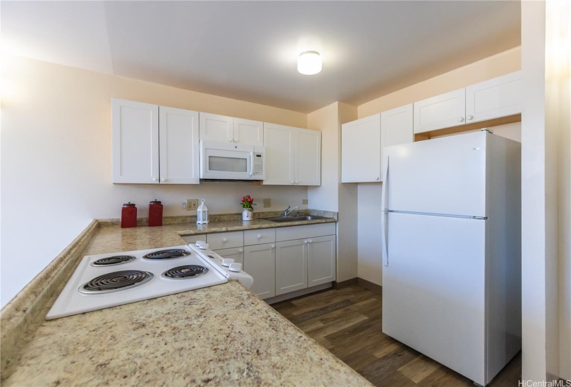 More kitchen - but see the space next to the fridge, think about adding a rolling butcher block island with extra storage. You’re welcome.