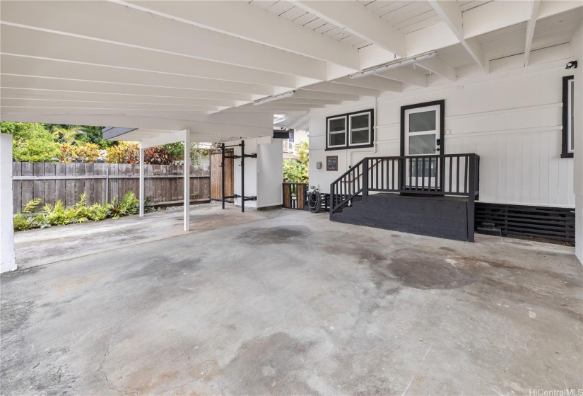 Main entry to the one- bedroom secondary unit is through the carport.