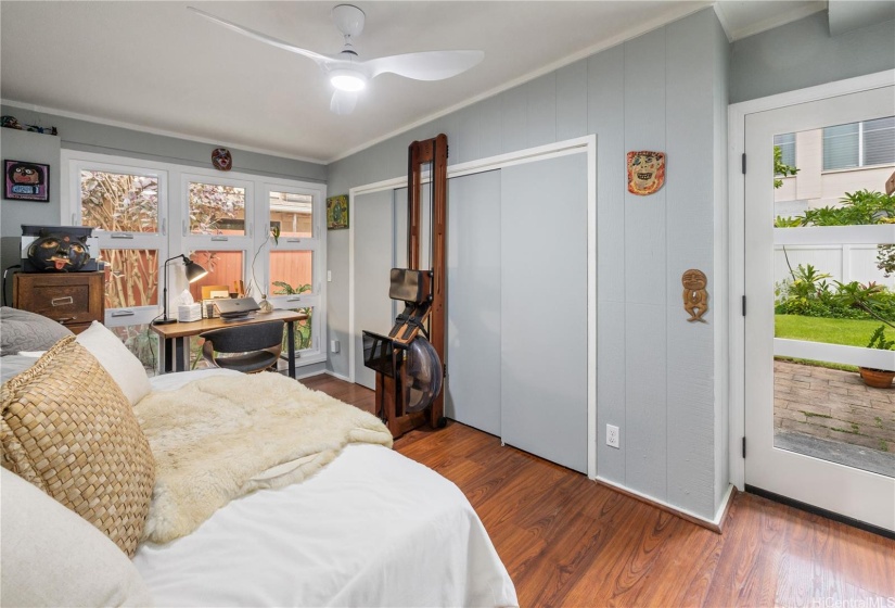 The door in this bedroom opens to the garden and covered lanai.