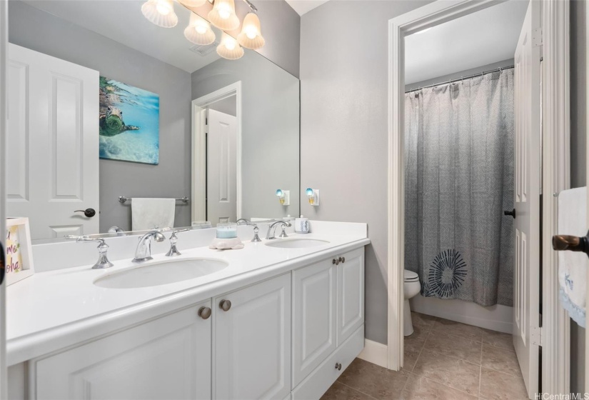 Hallway bathroom features dual sinks