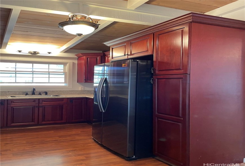 Kitchen is equipped with a double door Samsung refrigerator.