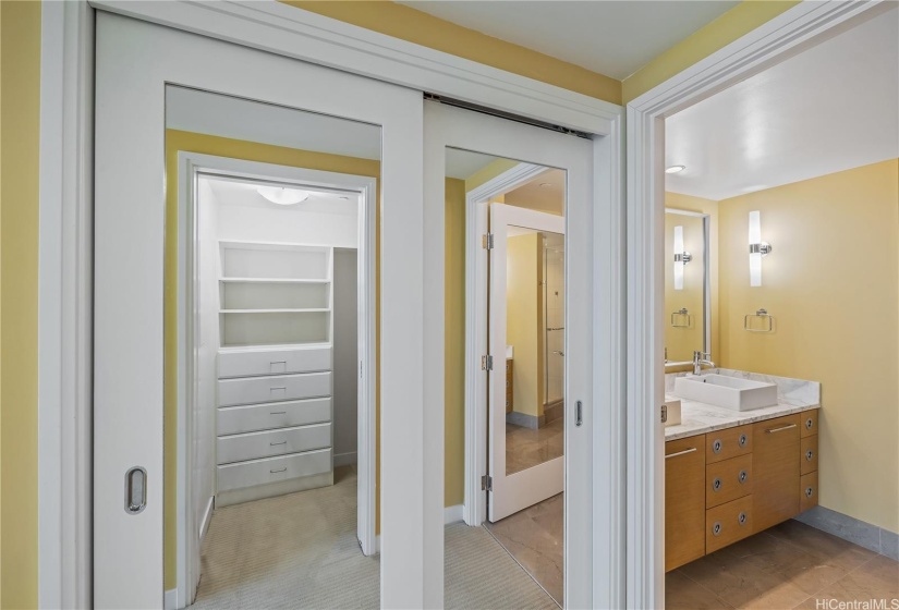 The walk-in closet of the Primary Bedroom includes a closet system and custom mirrored doors.