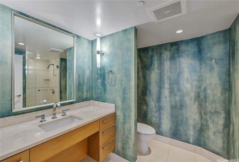 Second Bathroom with Walk-In Shower, dramatic custom paint, and interesting curved wall, creates a striking bathroom.