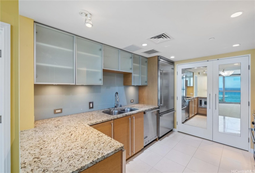 You will love the bright and open kitchen with its modern cabinetry, stainless steel Viking appliances, GAS range, and custom mirrored doors to the pantry so that you can enjoy the ocean view in both directions!