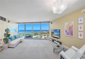 Virtually staged Living room with magnificent azure blue ocean in the daytime and golden sunsets in the evening.