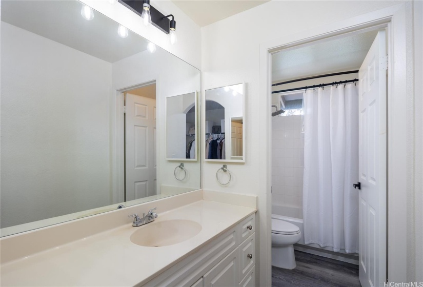 Primary En-suite with double vanities, andseparate restroom and a private tub area.