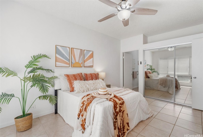 Large primary bedroom with ensuite with large closet and overhead storage above