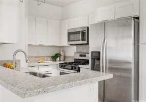 Fully remodeled kitchen with quartz counter tops, real wood shaker cabinets and stainless steel appliances