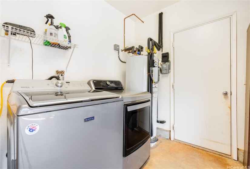 Washer, dryer, water heater & utility sink located in the garage.