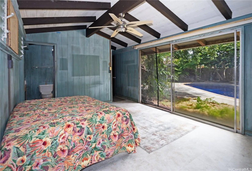 Primary bedroom opens to pool.