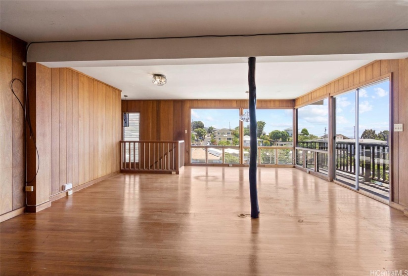 2nd level living room with Ohia posts, interior staircase to basement level