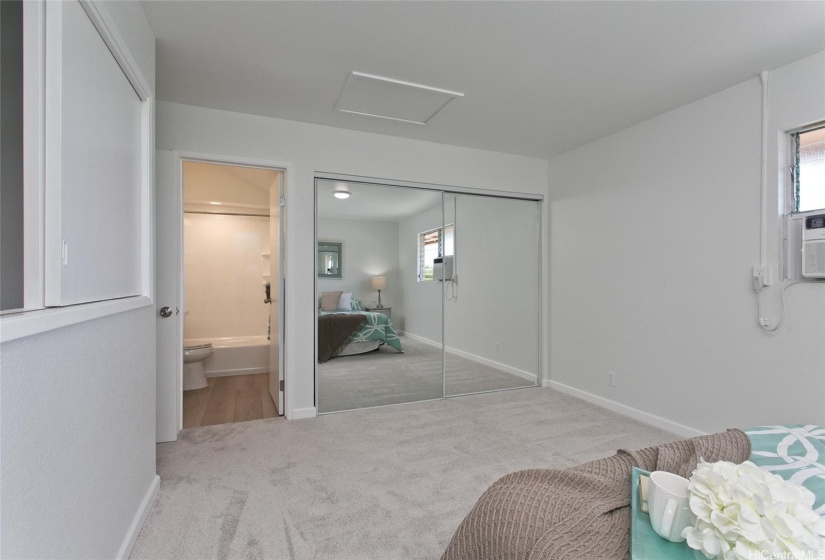 The large primary bedroom has room for a chaise lounge, desk or other furinture.