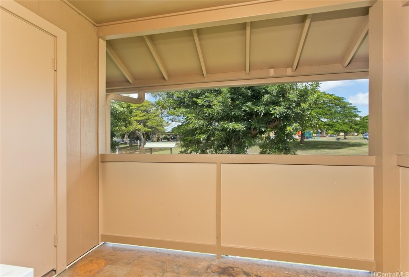 Covered lanai with park view and storage closet.