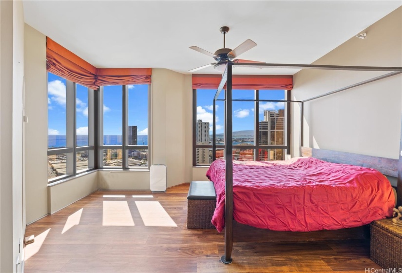 Primary bedroom with views out to the ocean and Honolulu city lights.