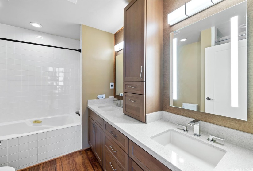 Double sinks in your primary bedroom with soaking tub and separate shower.