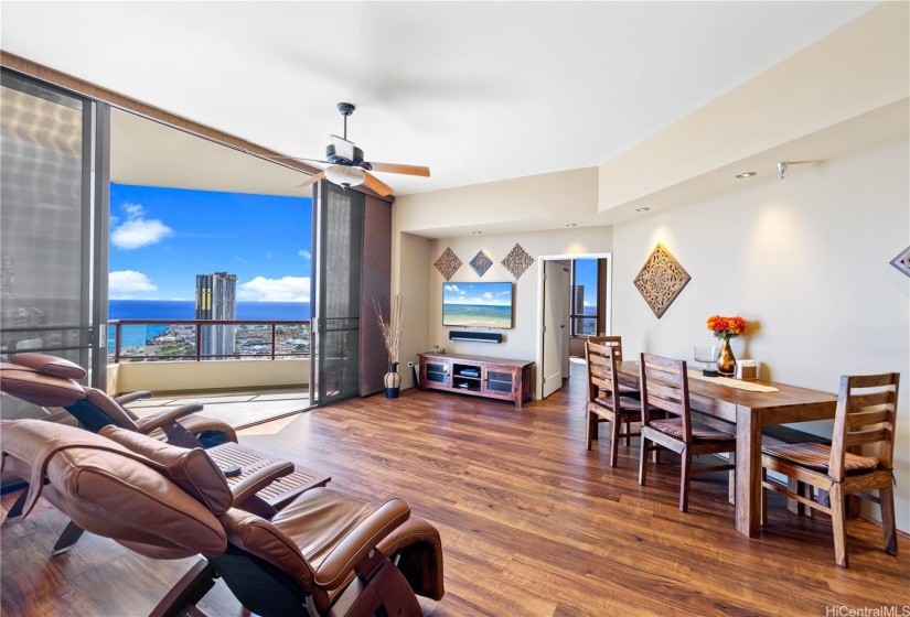 Living area with dining table and entertainment center.