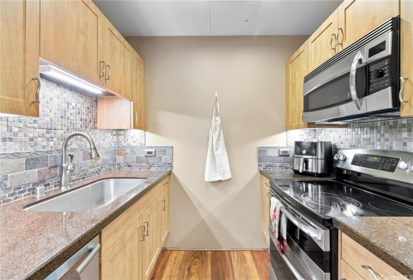 Remodeled kitchen with granite countertops, hardwood cabinets and stainless steel appliances.