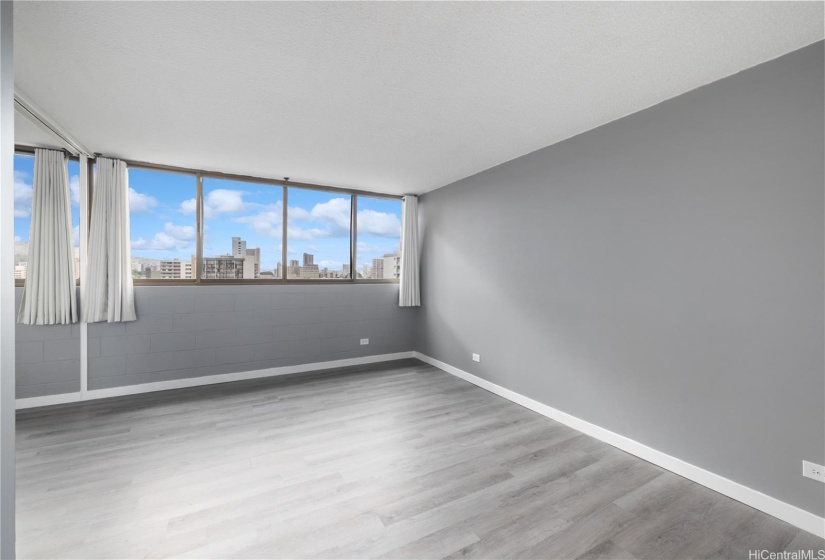 Spacious living and dining room with views of the city