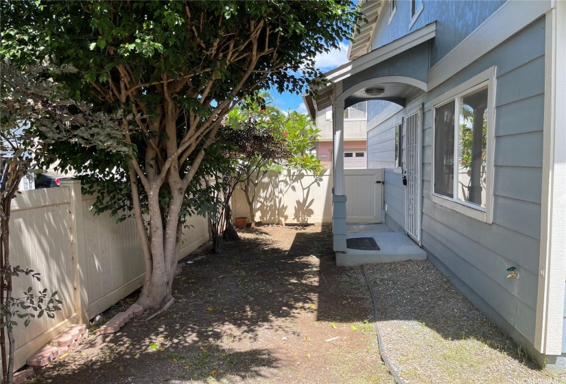 Side of house with gated front door entrance