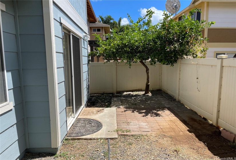 Back of house with a cozy patio.
