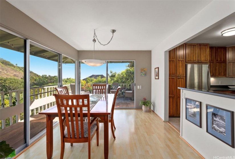 dining room with lanai in the distance and open kitchen to the right