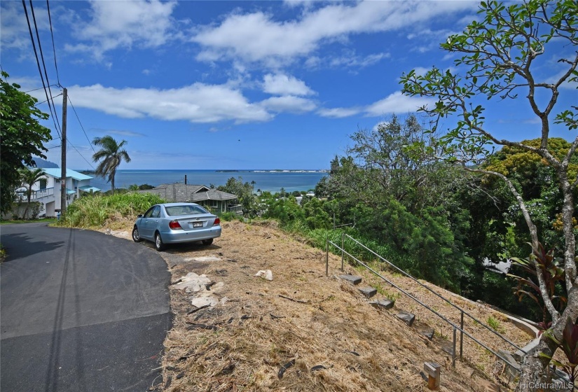 Upper view of lot with Kokokahi Place on left.   Dead end of street is just past the blue-roofed house to the left in this photo.  Quiet and limited cars. Views!!