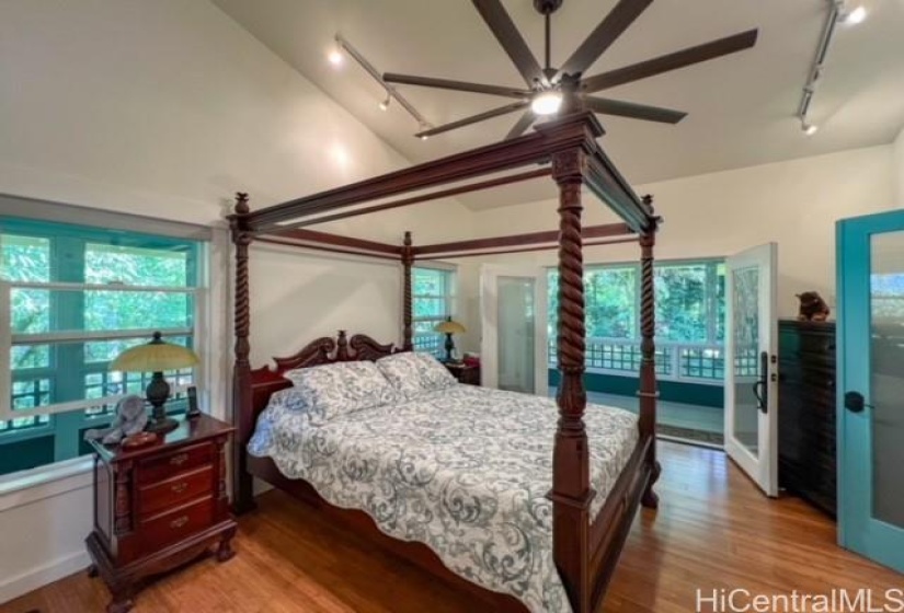 Primary bedroom looks out the double glass doors to the lanai