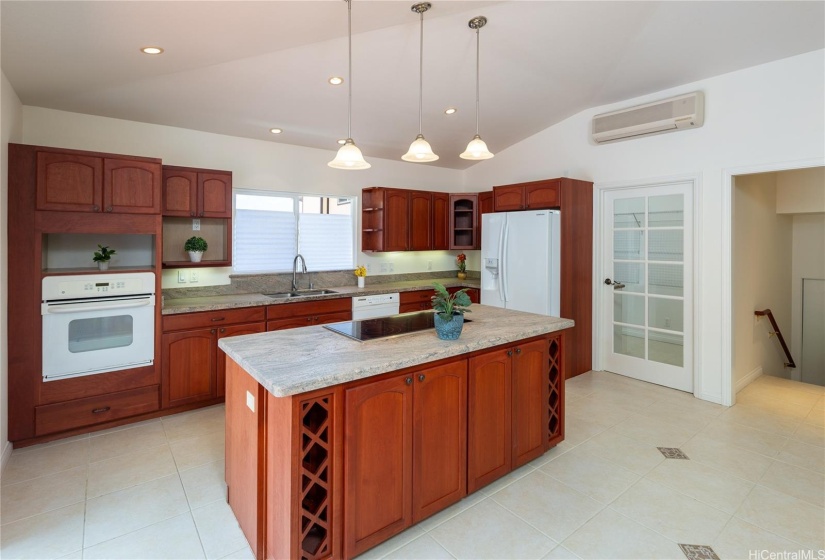 Another view of the kitchen.  The door opens into a spacious pantry for easy storage.  The stairs go to the 2 car enclosed garage.