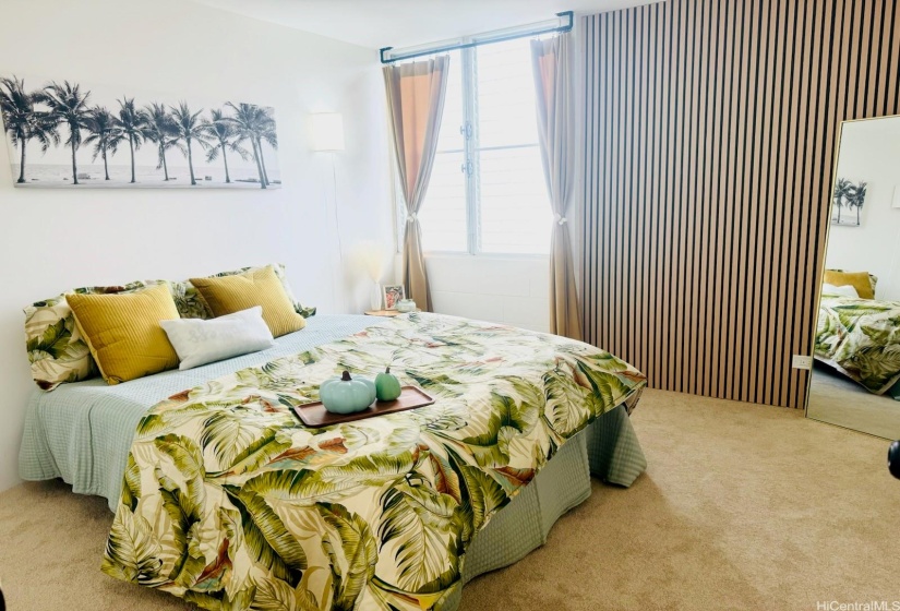 Primary bedroom designed w wood slat focus wall, new curtain fixture mounted into the concrete ceiling, display shelves, & additional wall mounted lighting fixtures.