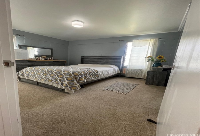 Primary bedroom with window a/c unit