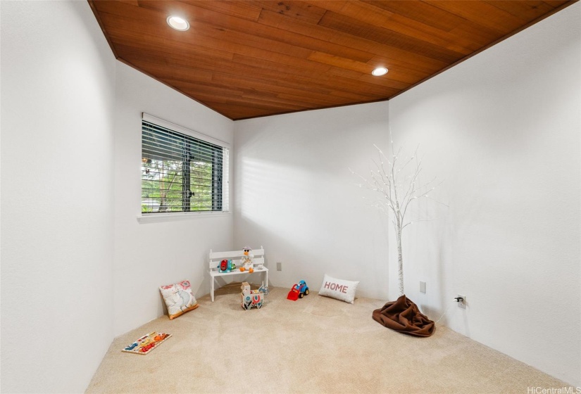 A hall bedroom nearest the stairs to the upper level
