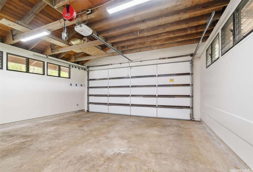 Garage just repainted so ready for your move-in.  Workbench to the left.  Massive storage above here, as well as to the upper left of the workbench area.