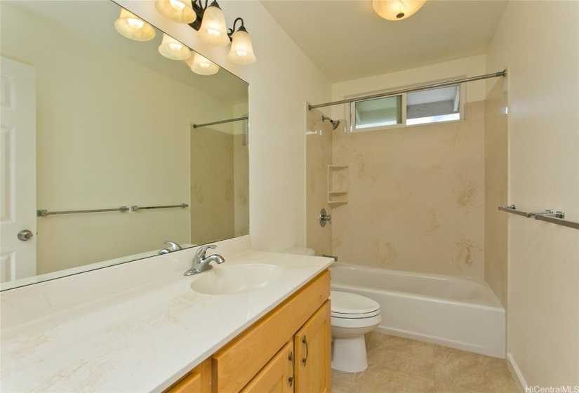 The large bathroom on the second floor includes both a shower and tub for versatility and comfort.