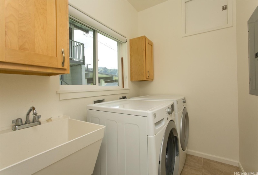 A dedicated laundry room on the first floor features a utility sink and ample storage space, making laundry a breeze.