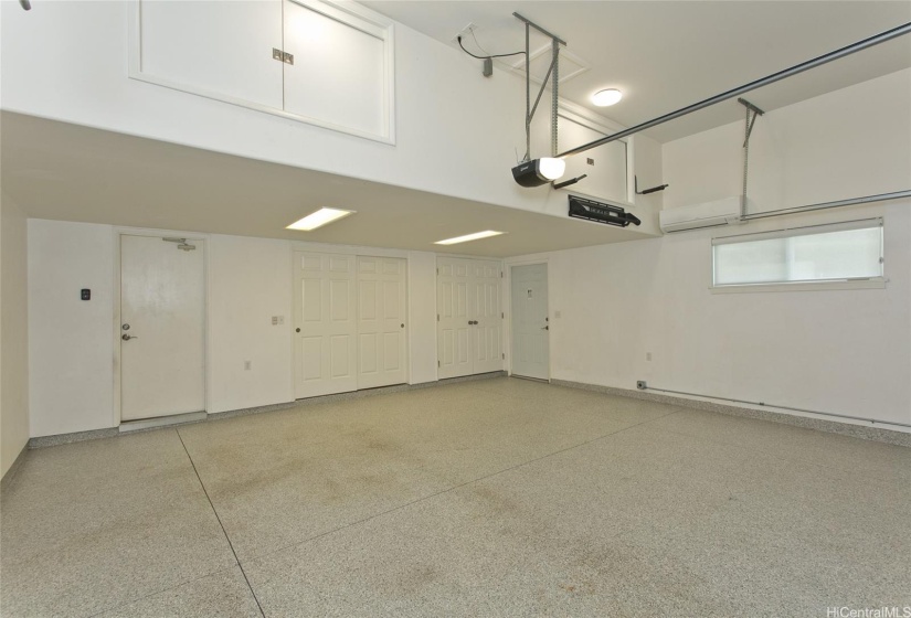 The oversized two-car garage includes additional storage space for tools or equipment.