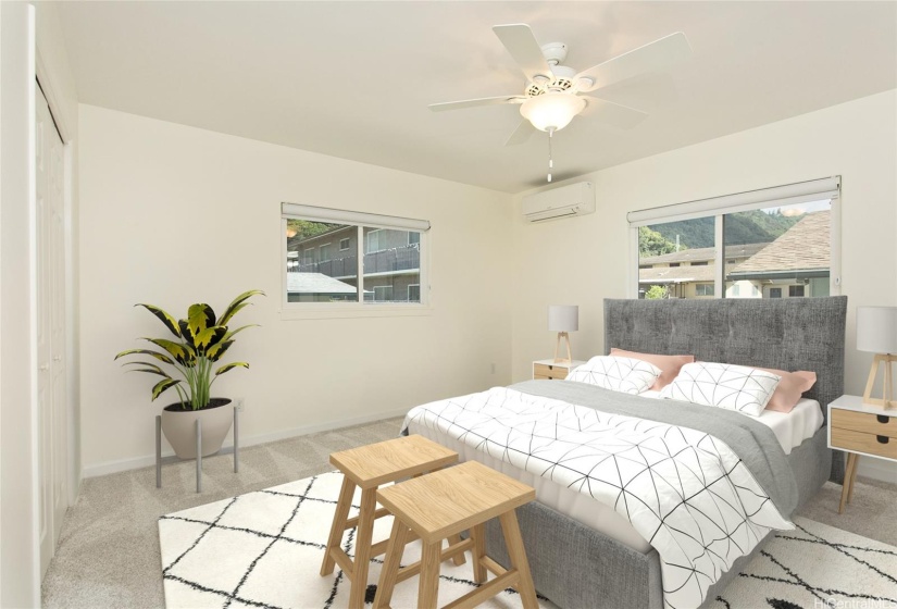 The primary bedroom, located at the back of the home on the second floor, is bathed in natural light and offers serene valley and mountain views. Photo is virtually staged.