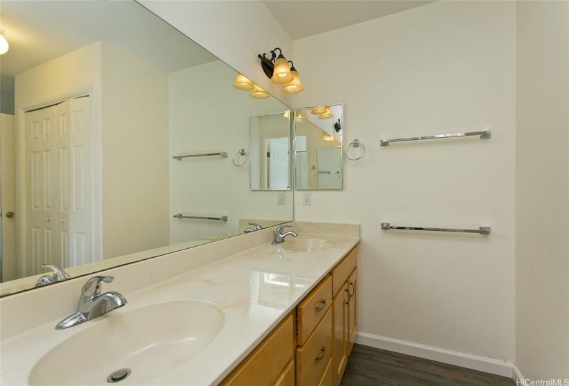 The spacious primary bathroom includes dual sinks and ample storage, providing both functionality and style.